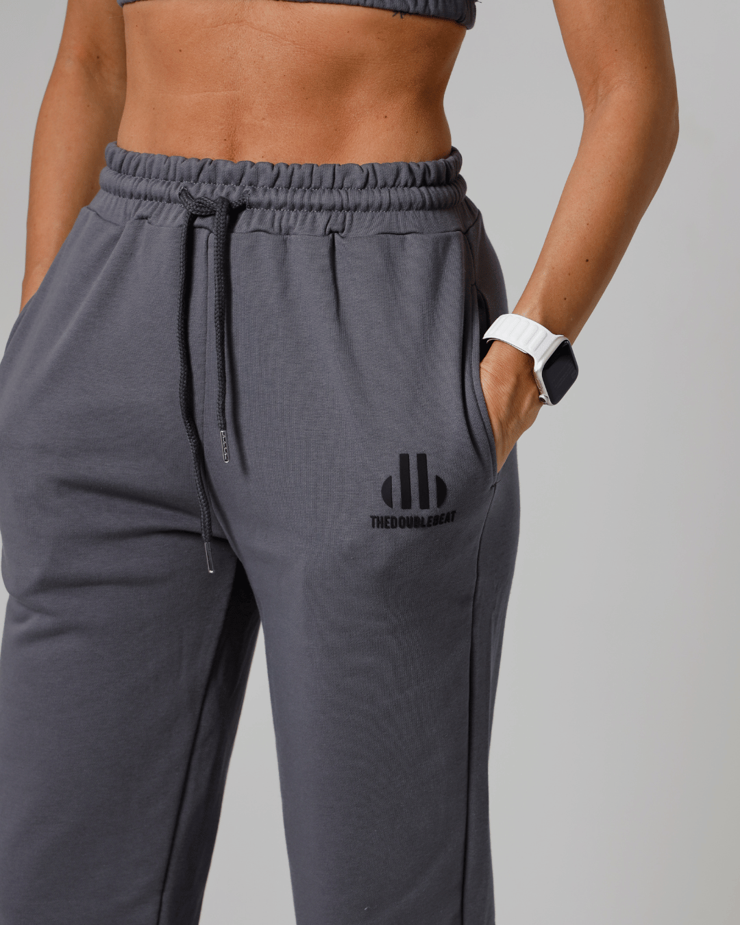 women Gray sweatpants with a logo on a gray background