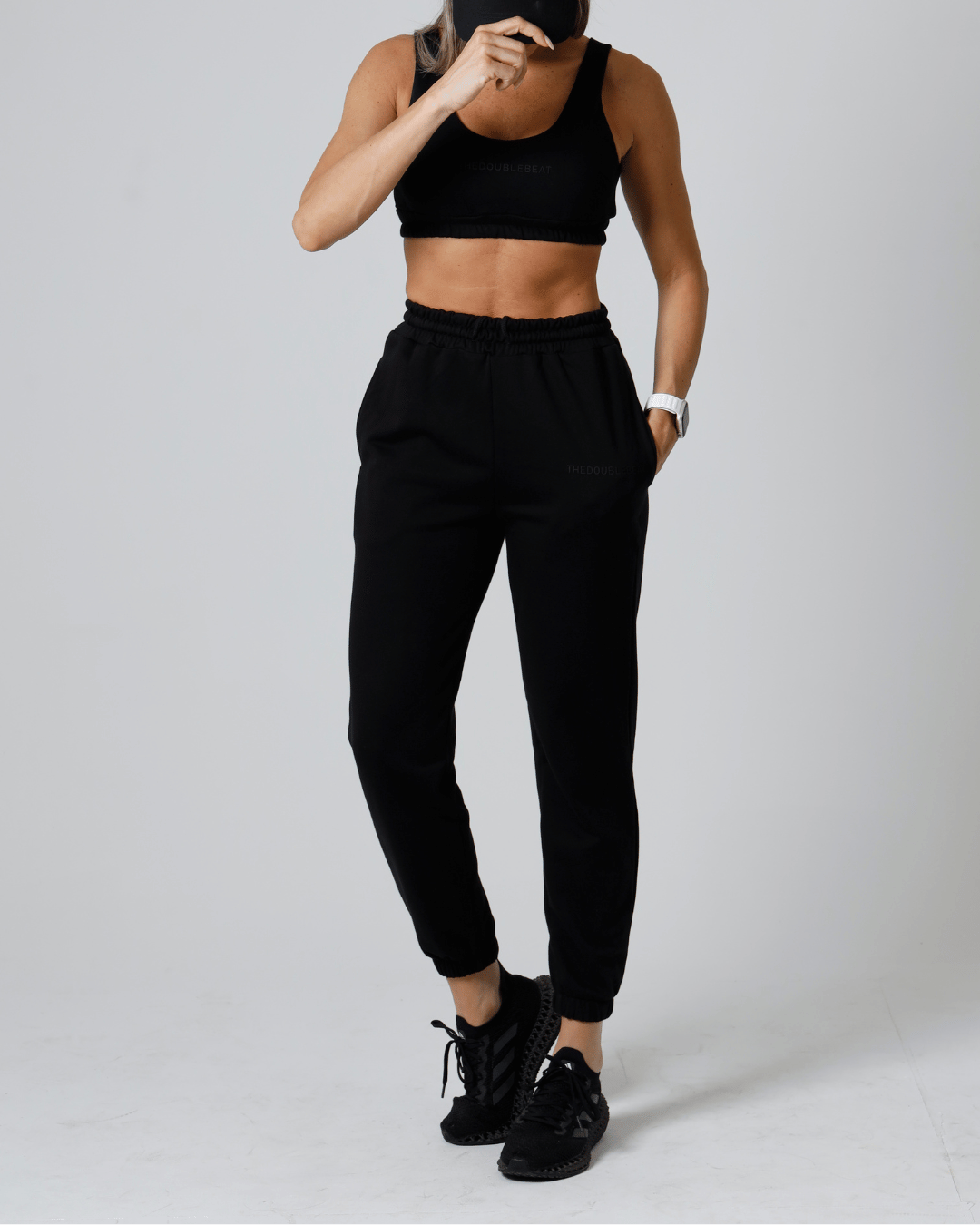 women wearing a black athletic outfit on a white background
