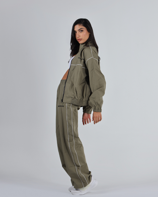 Woman wearing a green tracksuit on a white background